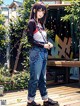 A woman standing on a wooden deck next to a tree.