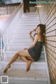 A woman sitting on the steps of a house.