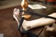 A woman's legs in black stockings sitting on a table.