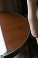 A close up of a person's hand on a table.