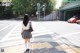 A woman standing in the middle of a crosswalk.