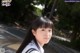 A young woman in a school uniform posing for a picture.