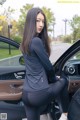 A woman sitting in the driver's seat of a car.