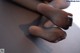 A close up of a person's feet on a table.